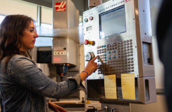 Student working manufacturing hardware